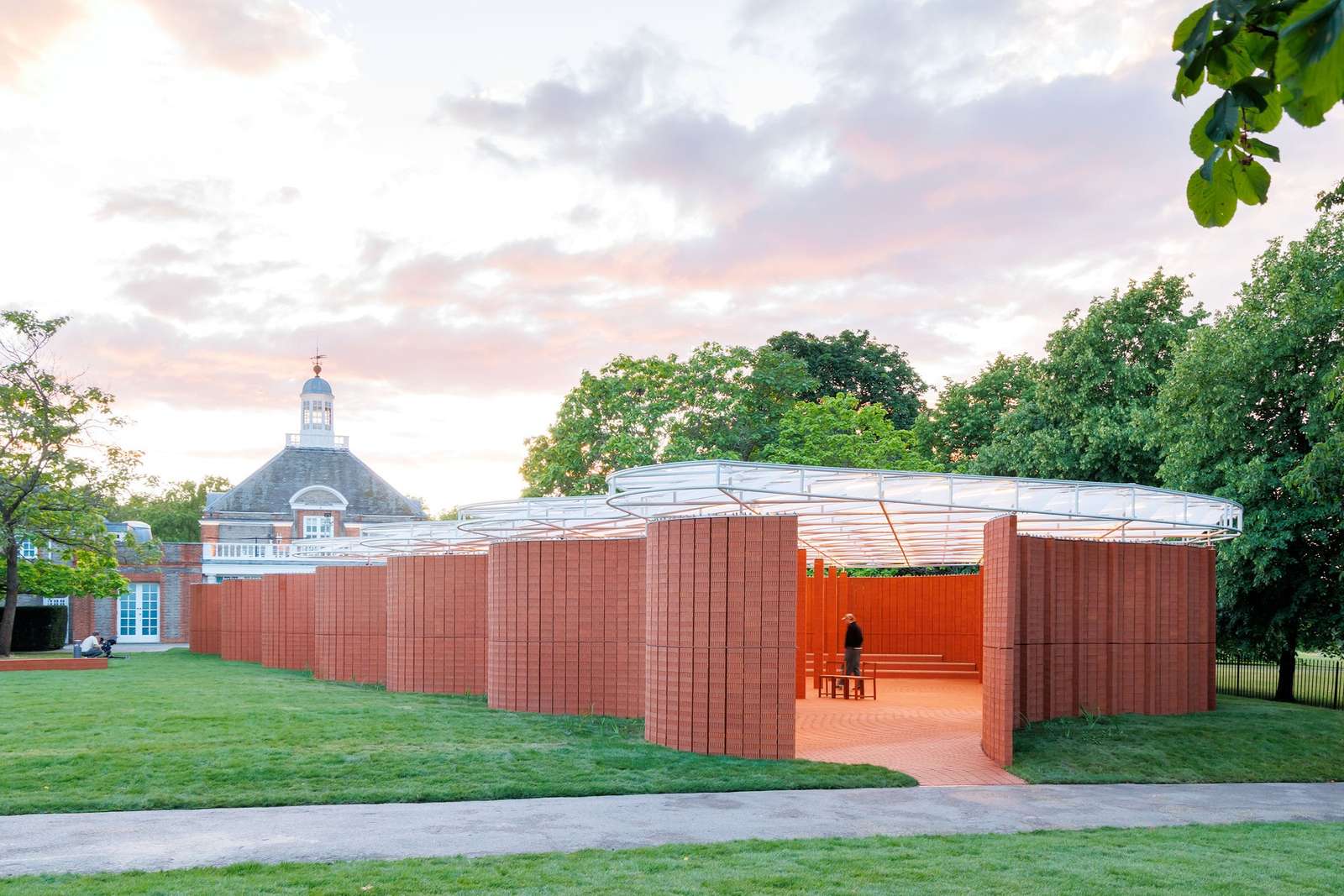 Serpentine Pavilion red brick curved wall sunset evening architecture London