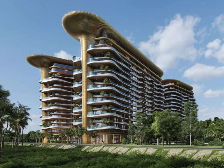 Exterior perspective of Montemar Residential towers in Gonio featuring organic curved facades, undulating green balconies, and golden flared structural crowns.