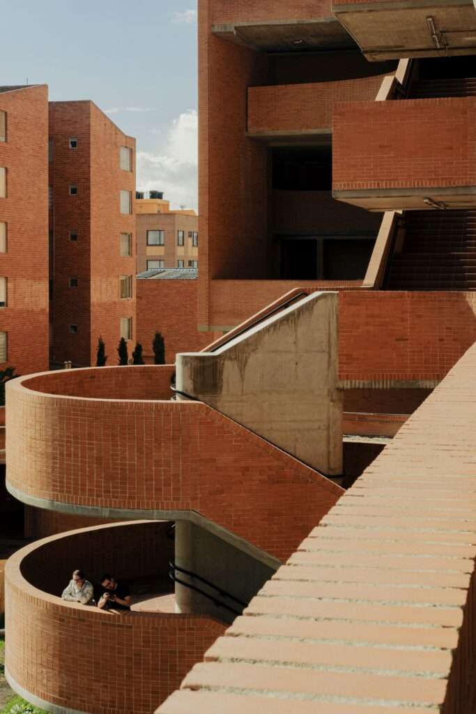 Detail view of a curved brick ramp and stair structure within the courtyard of Feliza Bursztyn School.