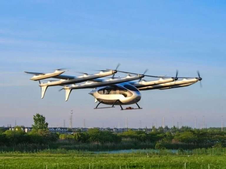 AutoFlight Prosperity eVTOL aircraft with multiple rotors flying over a green field.