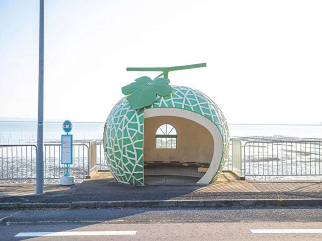Cantaloupe melon-shaped bus stop shelter with textured net pattern along the Konagai coast.