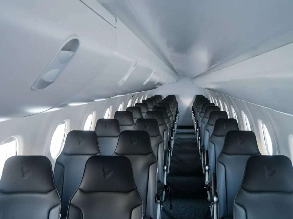 Interior cabin view of the Heart X1 aircraft featuring rows of dark leather passenger seats and overhead bins.