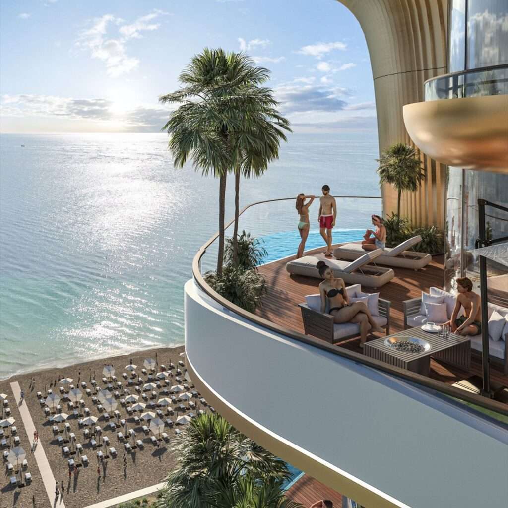 Residents relaxing on a spacious cantilevered balcony terrace with outdoor seating and unobstructed ocean view at Montemar Residential.