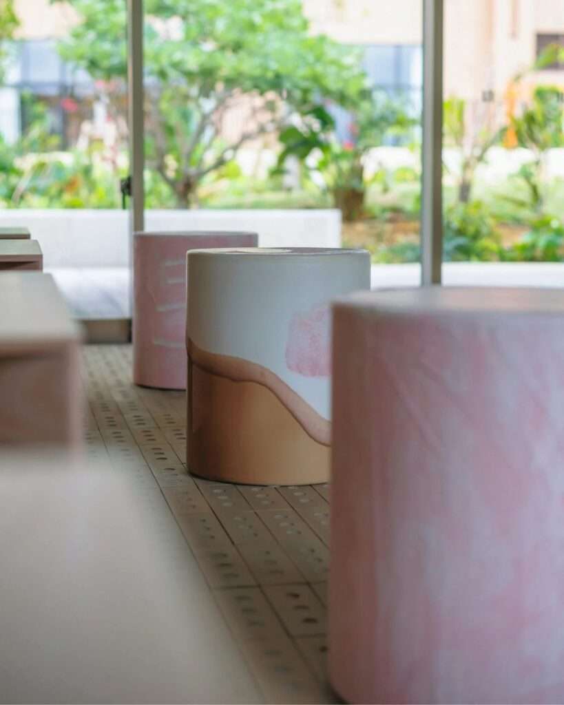 Close-up of handcrafted ceramic cylinder stools featuring pastel melting ice cream glaze patterns by NOTA shop.