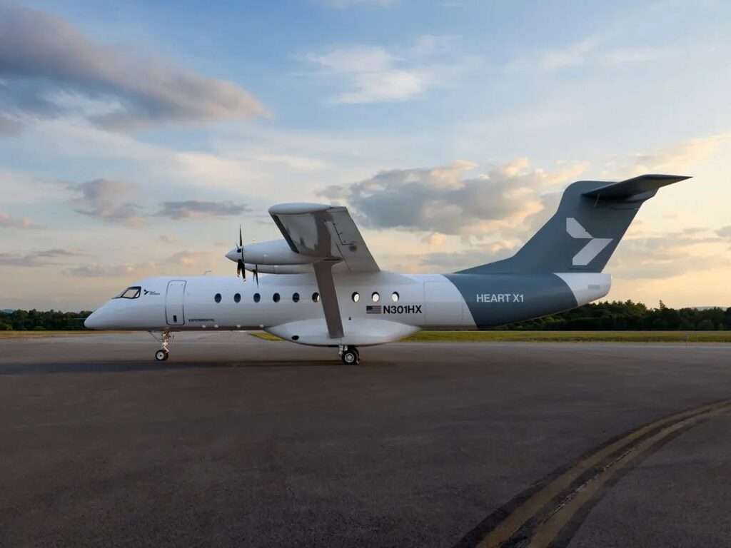 Side profile view of the Heart X1 experimental aircraft stationary on the airport tarmac under a cloudy sky.
