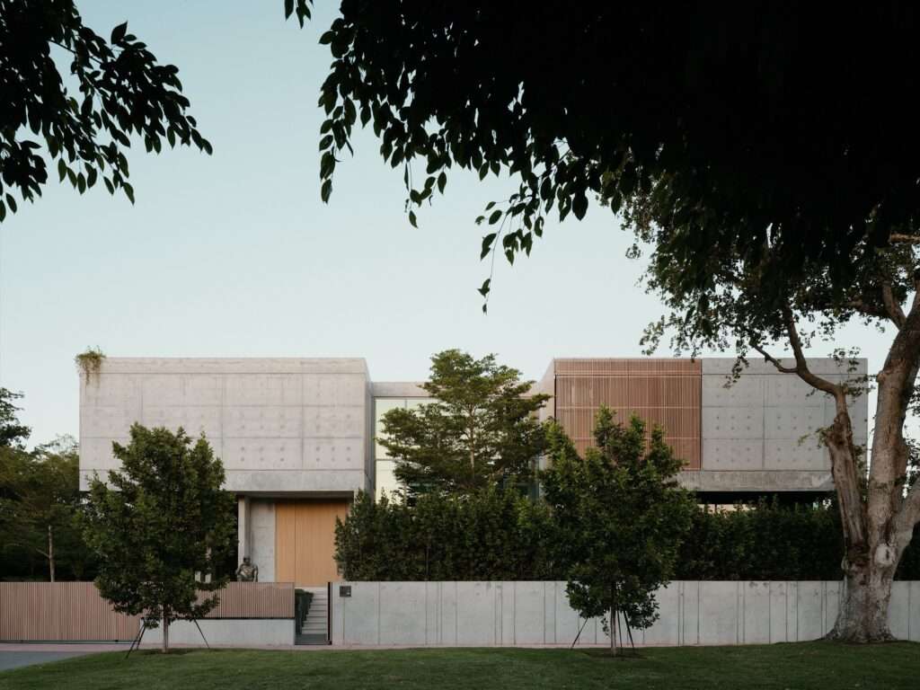 Front architectural elevation of Cherokee House highlighting the central glazed vertical circulation core between two concrete blocks.