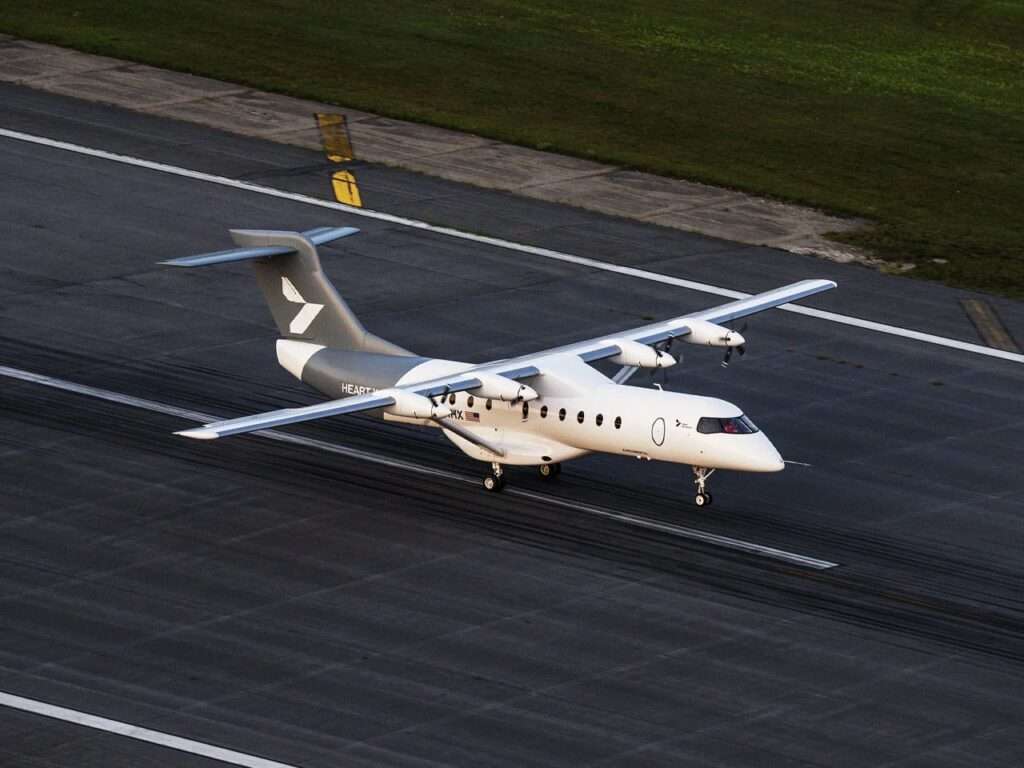 High aerial view of the Heart X1 aircraft taxiing along an asphalt airport runway markings.