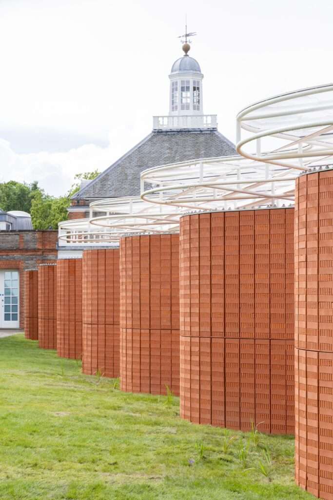 Detail of red brick wall and white steel lattice roof Serpentine Pavilion