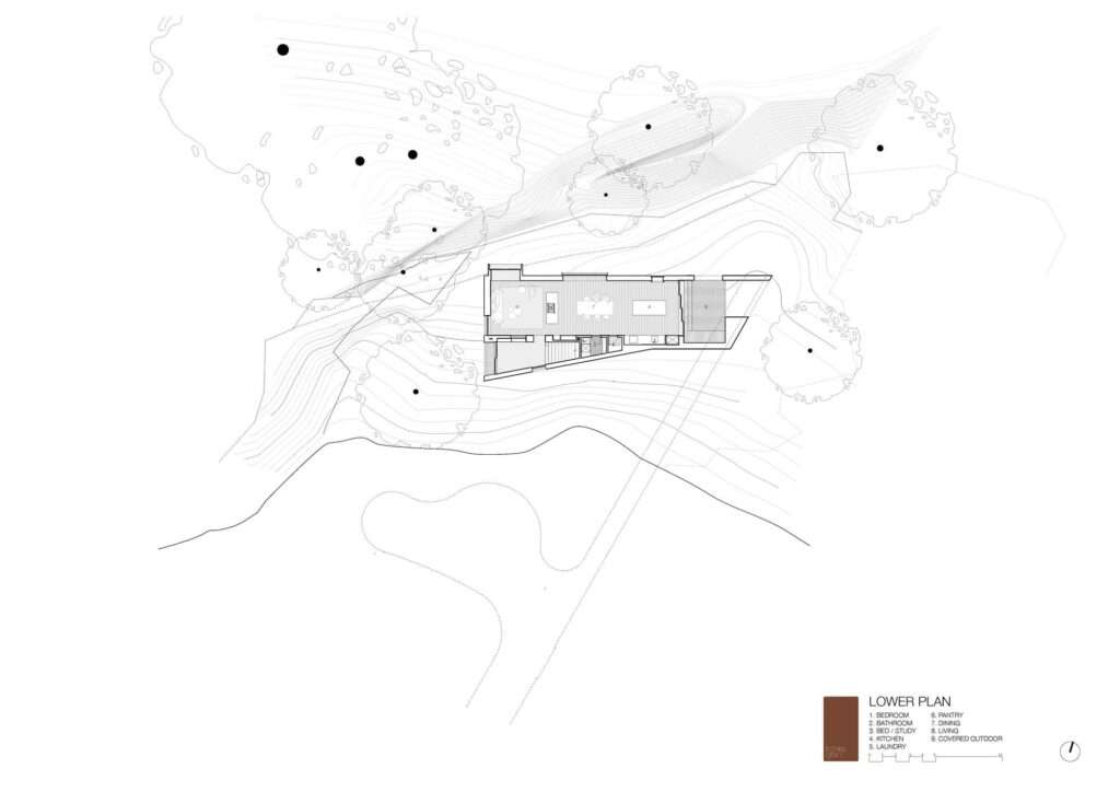 An architectural lower-level floor plan drawing for EA House, showing the spatial layout of living, kitchen, and dining areas embedded along the site's natural contours and rocky cliff.