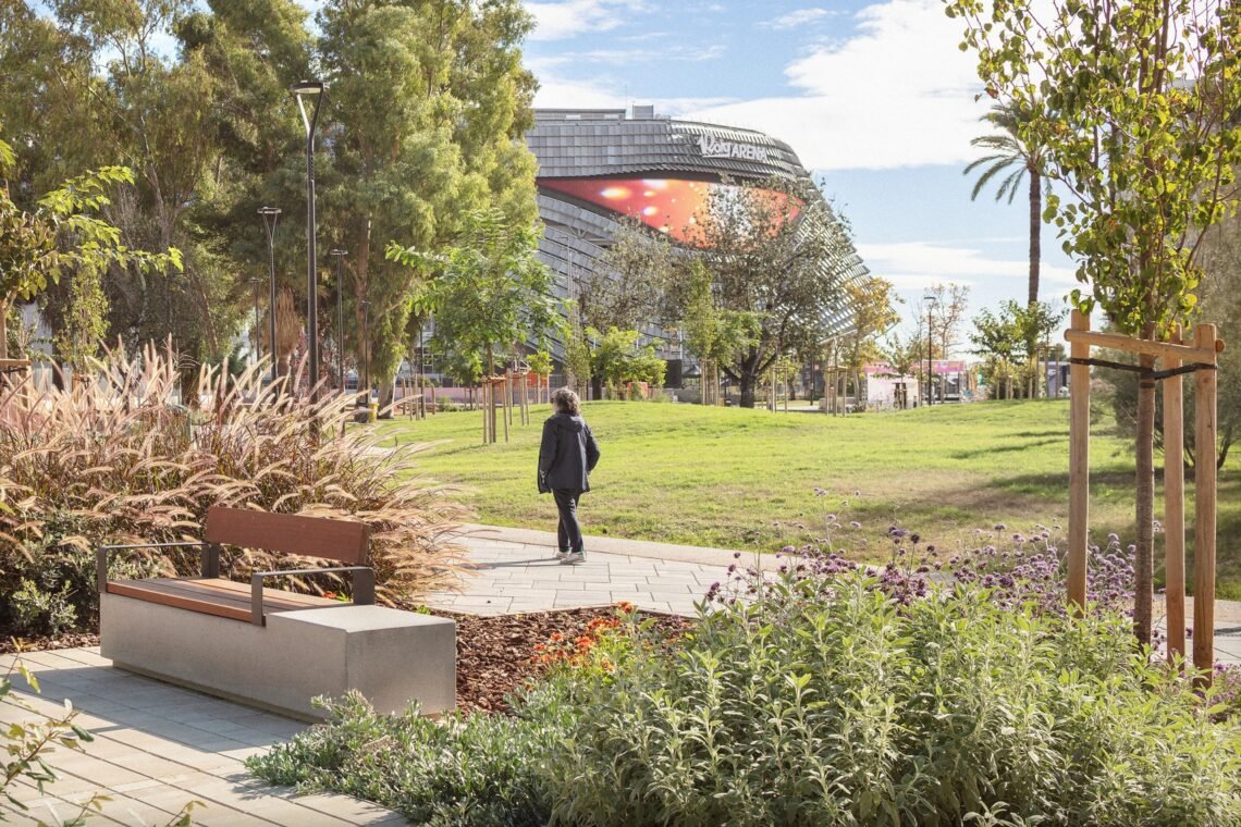 A pedestrian crossing the lawn-side path.