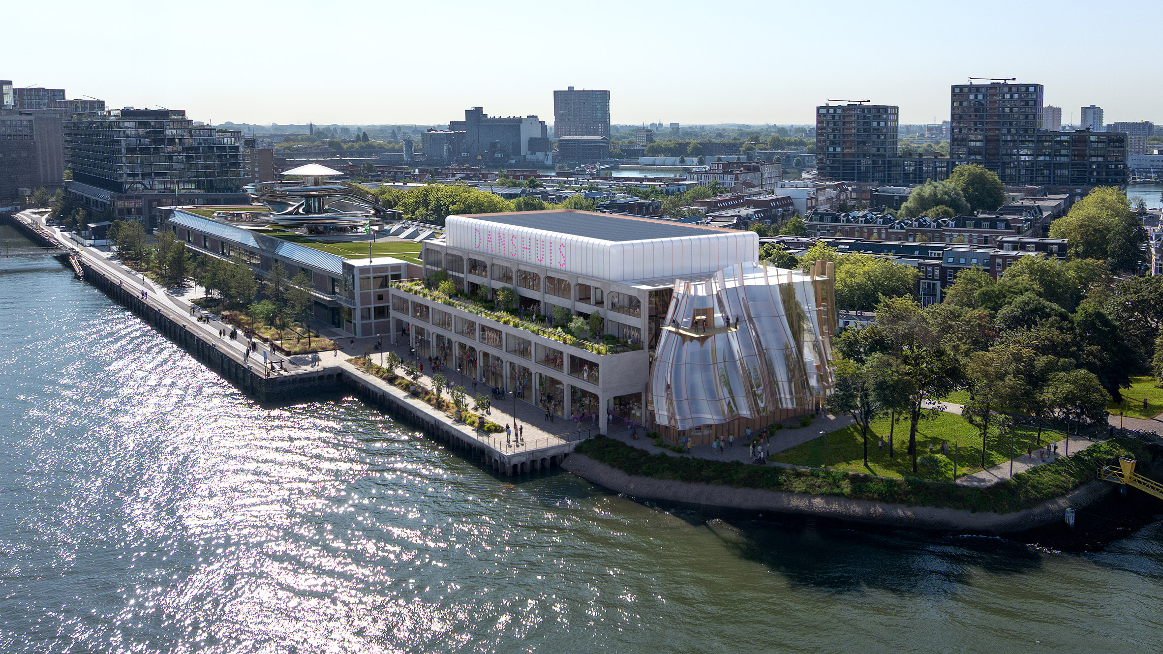 Aerial view showing a transformed art deco warehouse with a rippled glass extension along the waterfront quay
