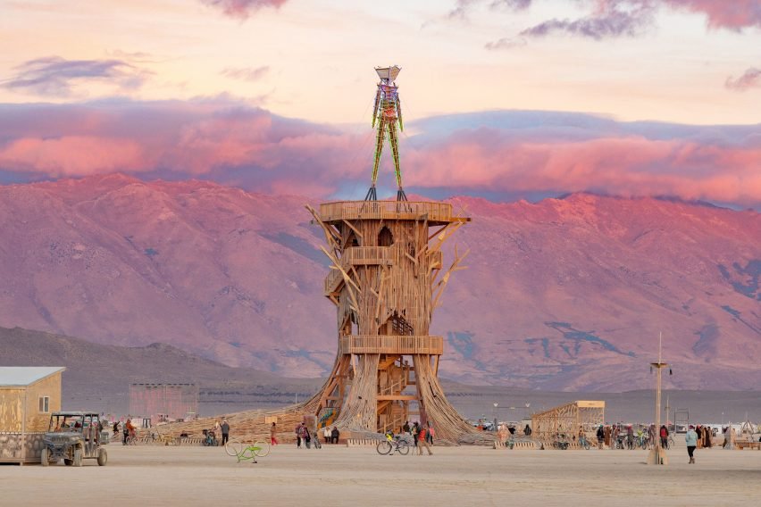 A tree-like pavilion with a double-helix staircase and recycled wood cladding on the Playa