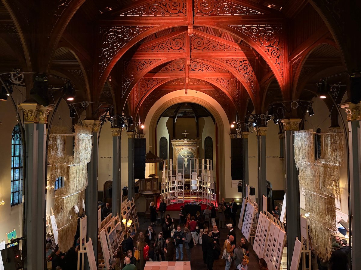 Crowd gathered in the nave of deconsecrated Sofienberg Church for triennale opening