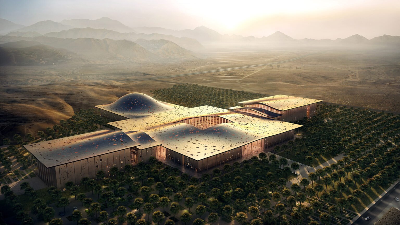 Aerial view showing complex building massing, central canopy structure, and surrounding landscaped grounds.
