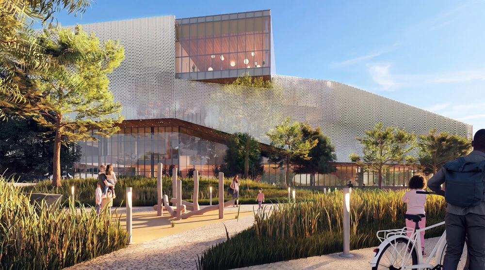 Exterior view showing perforated metal screening, glass volume, and landscaped walkway with outdoor equipment.
