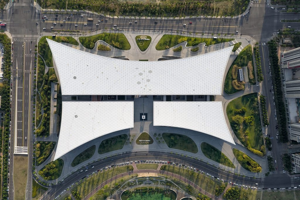 Direct top-down aerial photo of a large white roof divided into distinct symmetrical sections.