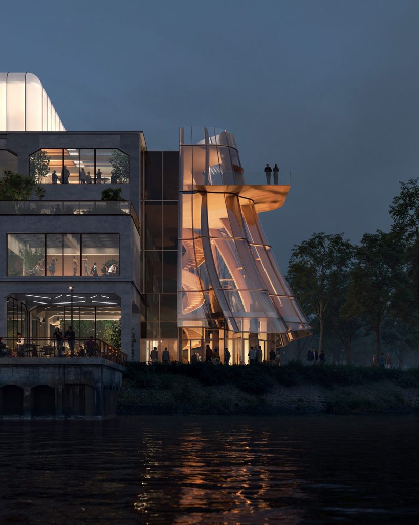 Illuminated four-story glass extension featuring an internal spiral staircase next to the masonry warehouse facade at night