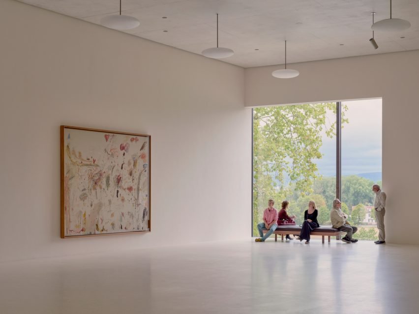 Interior gallery space with large windows showing treetops at Fondation Beyeler