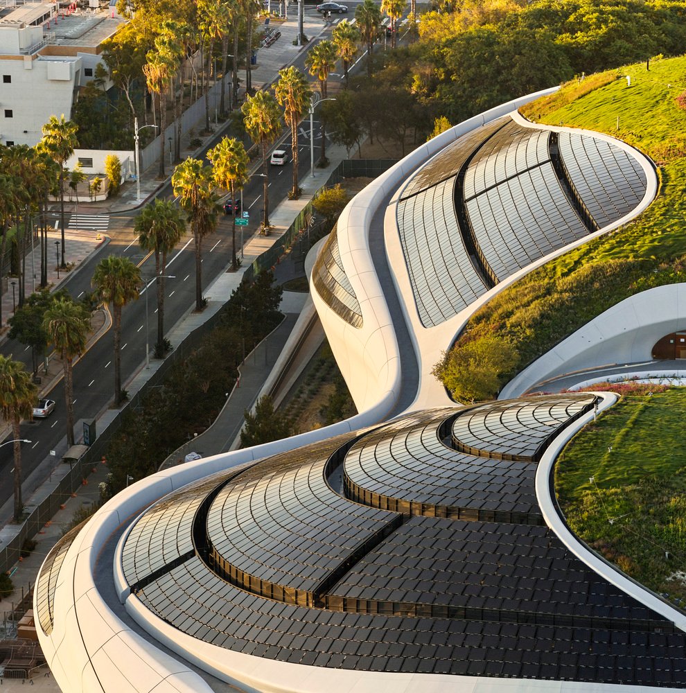 Close-up view of curved green roof sections and integrated panel assemblies on the museum structure.
