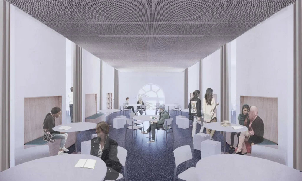 Open reading mezzanine featuring round study tables, seating nooks, and a perforated metal ceiling