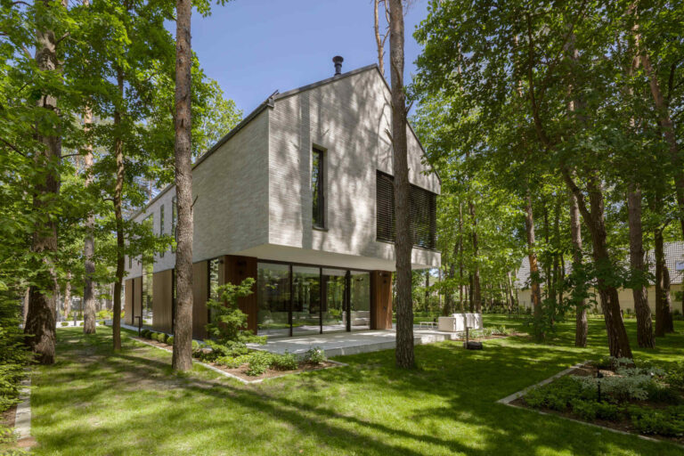 Two intersecting volumes give The Intersecting House near Warsaw its distinctive form. Designed by Exterio Architektura, the home combines pitched roofs, contrasting materials and a strong relationship with the surrounding pine forest.