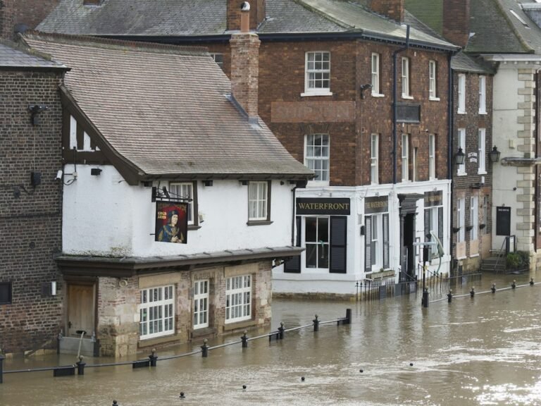 Floodwater covering an urban street near buildings