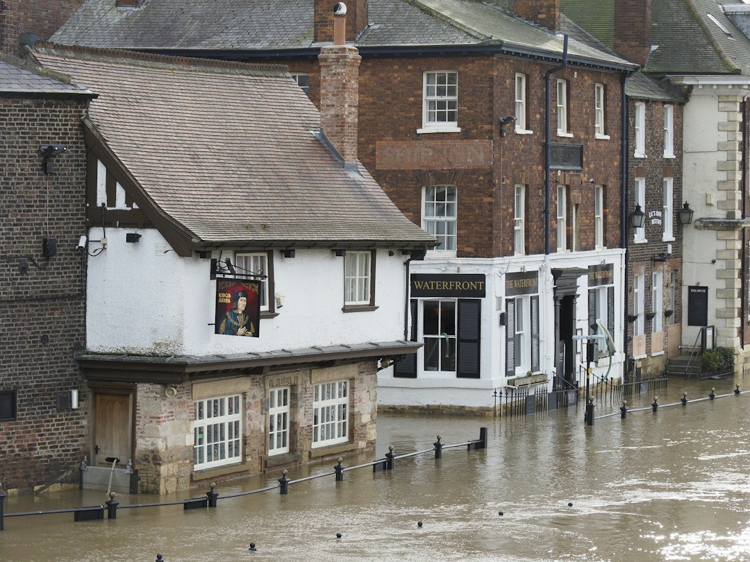 Floodwater covering an urban street near buildings