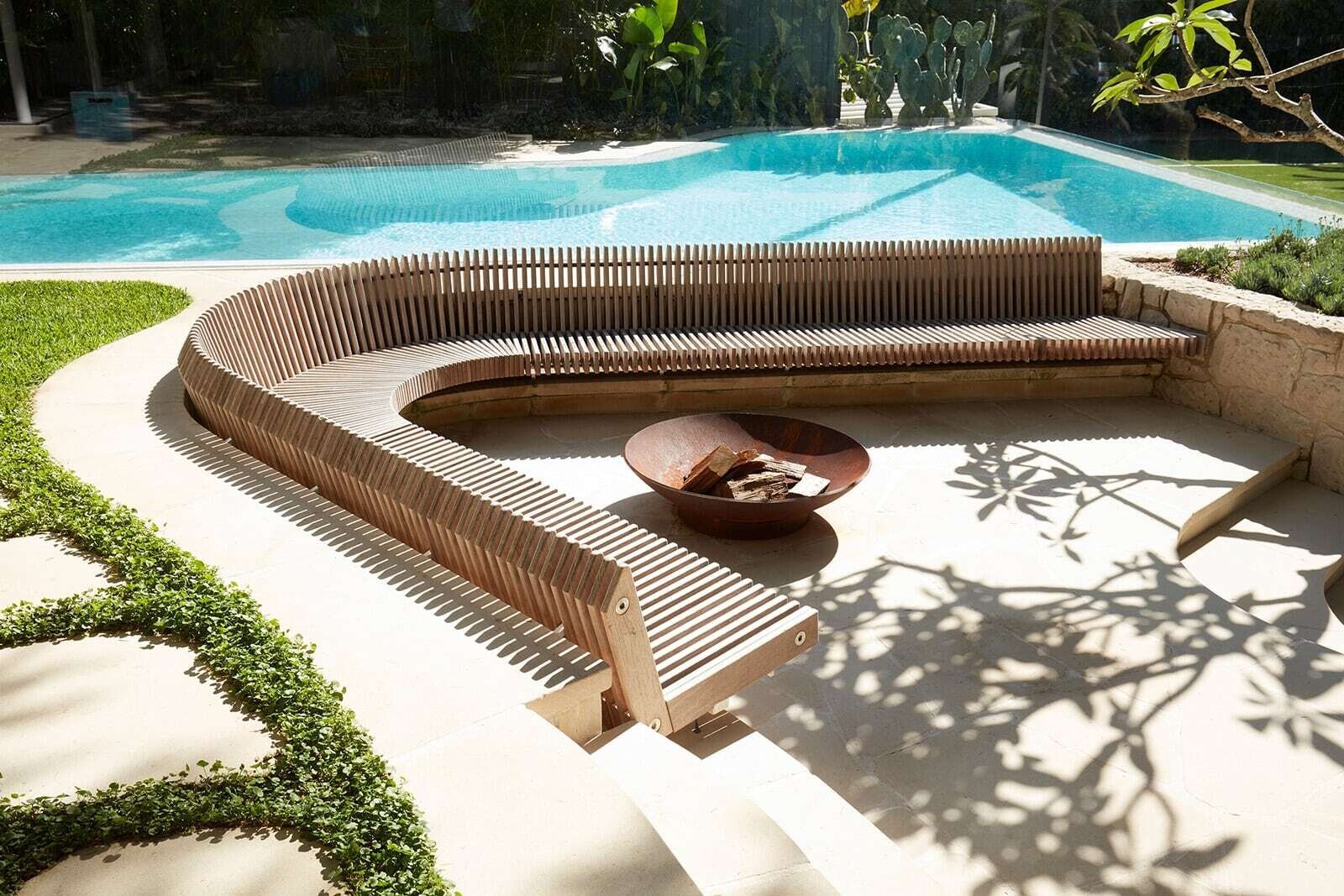 Curved sunken timber bench in the garden