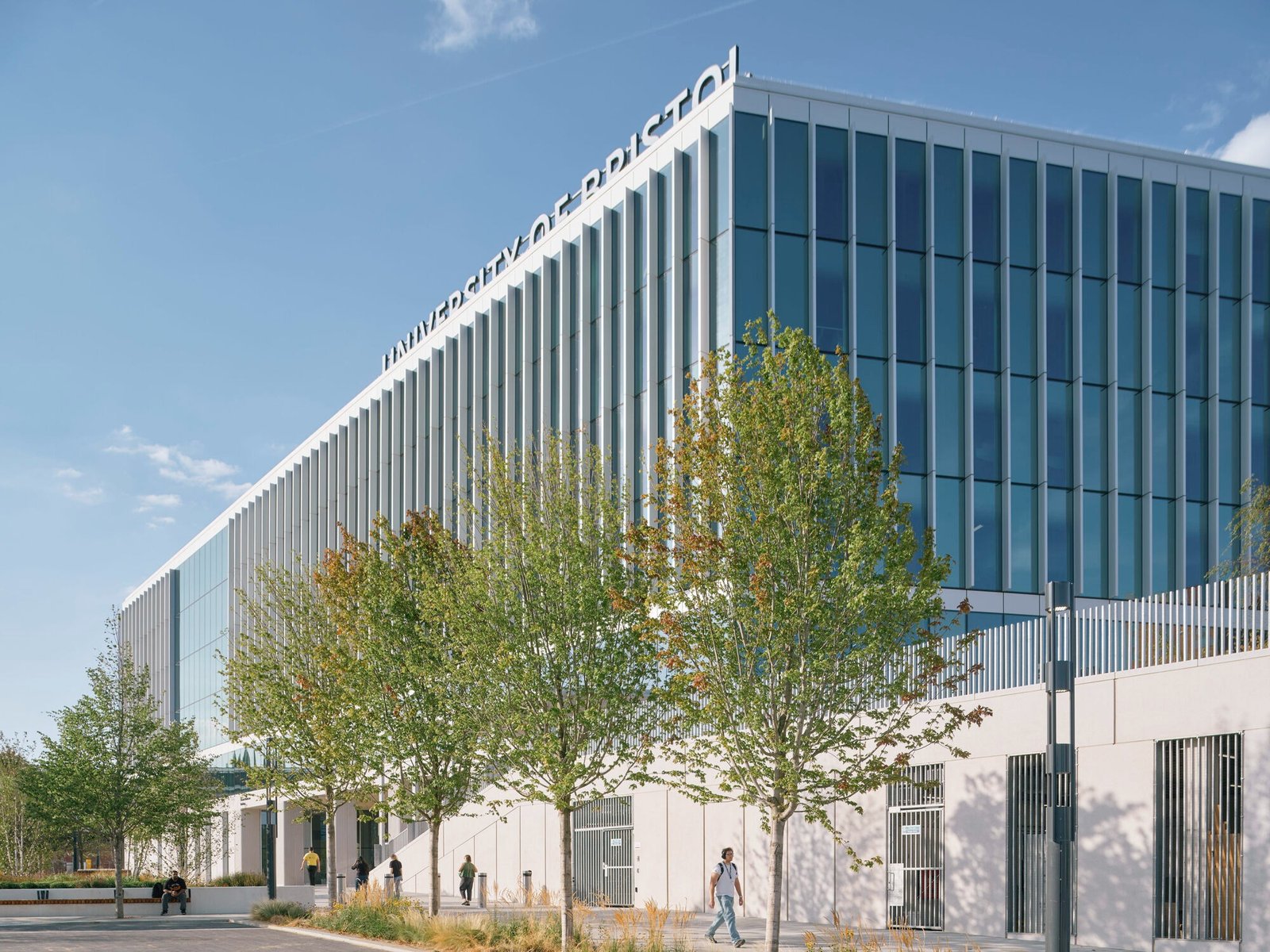 Exterior view of the glass facade of Temple Quarter Enterprise Campus at University of Bristol with street-level landscaping.