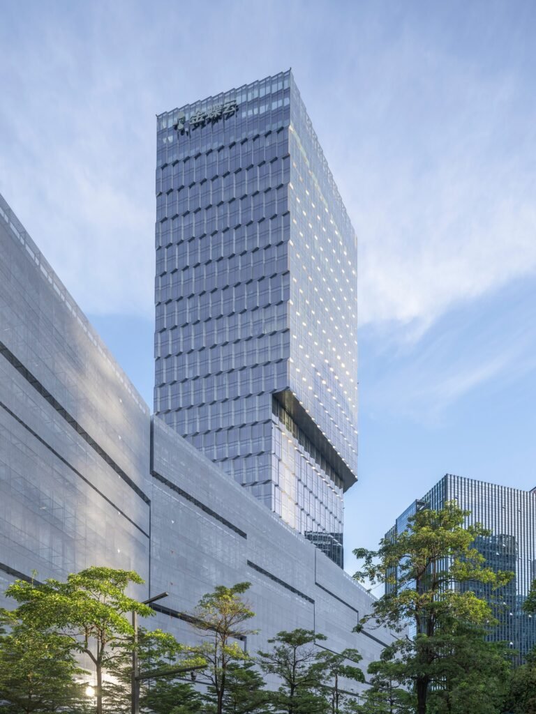 Low angle shot of Kingdee HQ Tower showing the prominent cantilever volume extending above the existing office wings.