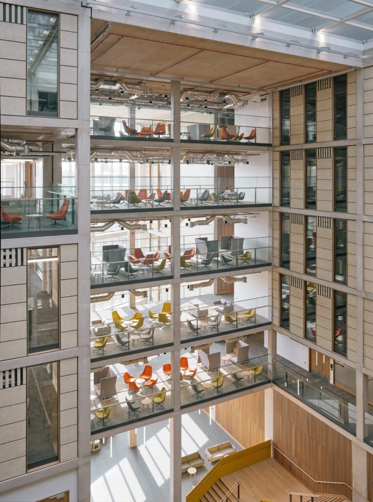Multi-story interior atrium of Temple Quarter Enterprise Campus with open study lounges and glass balustrades.