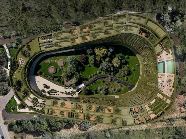 Top-down aerial view of LTR1 curved residential building surrounding a central dense forest and courtyard.