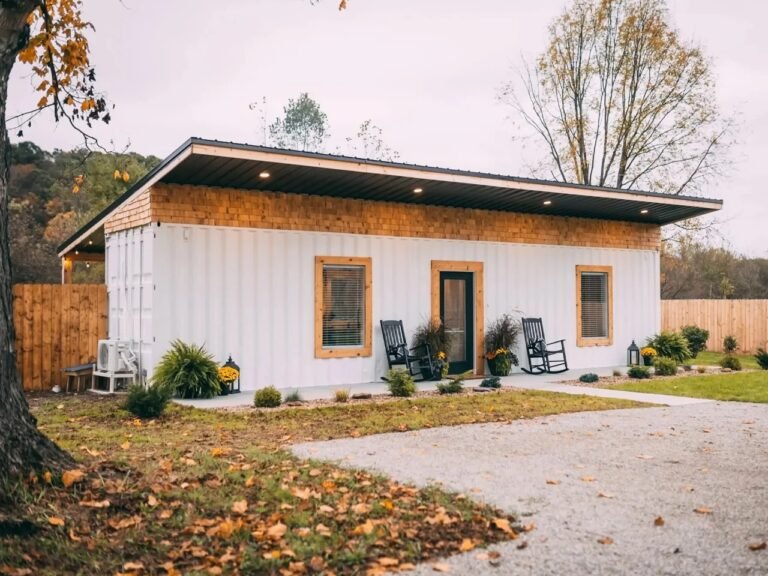 Exterior view of Luna Cottage, a white shipping container vacation rental with wood cladding trim in Hocking Hills, Ohio.