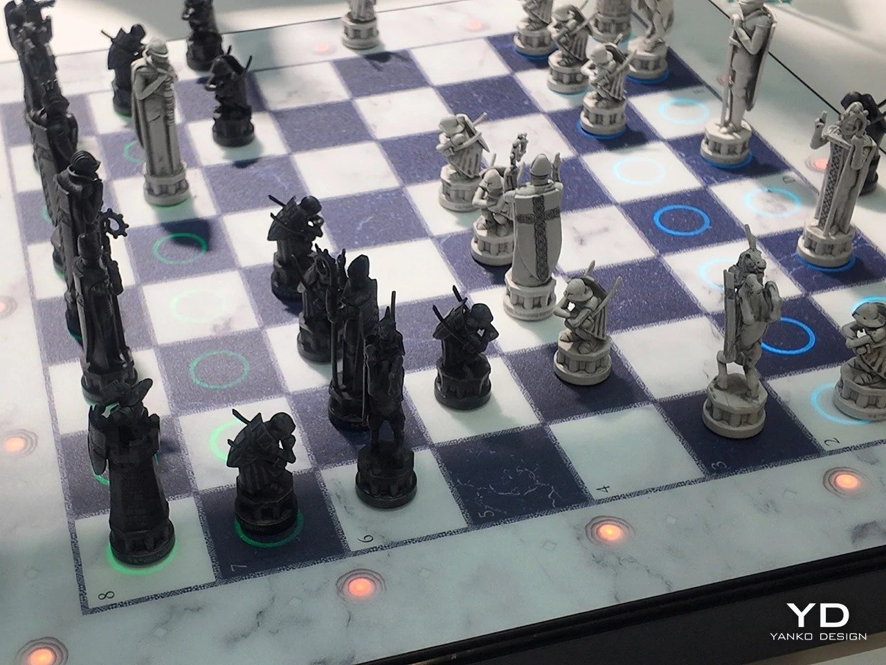 Sculpted chess pieces positioned on an illuminated marble chessboard featuring glowing LED circular indicators under the tiles.
