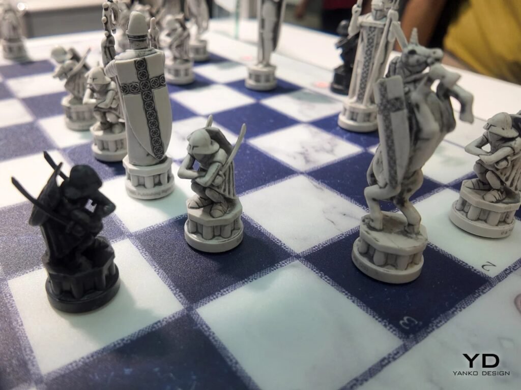 Close-up of sculpted knight and bishop chess pieces displaying detailed armor and relief textures on a marble chessboard.