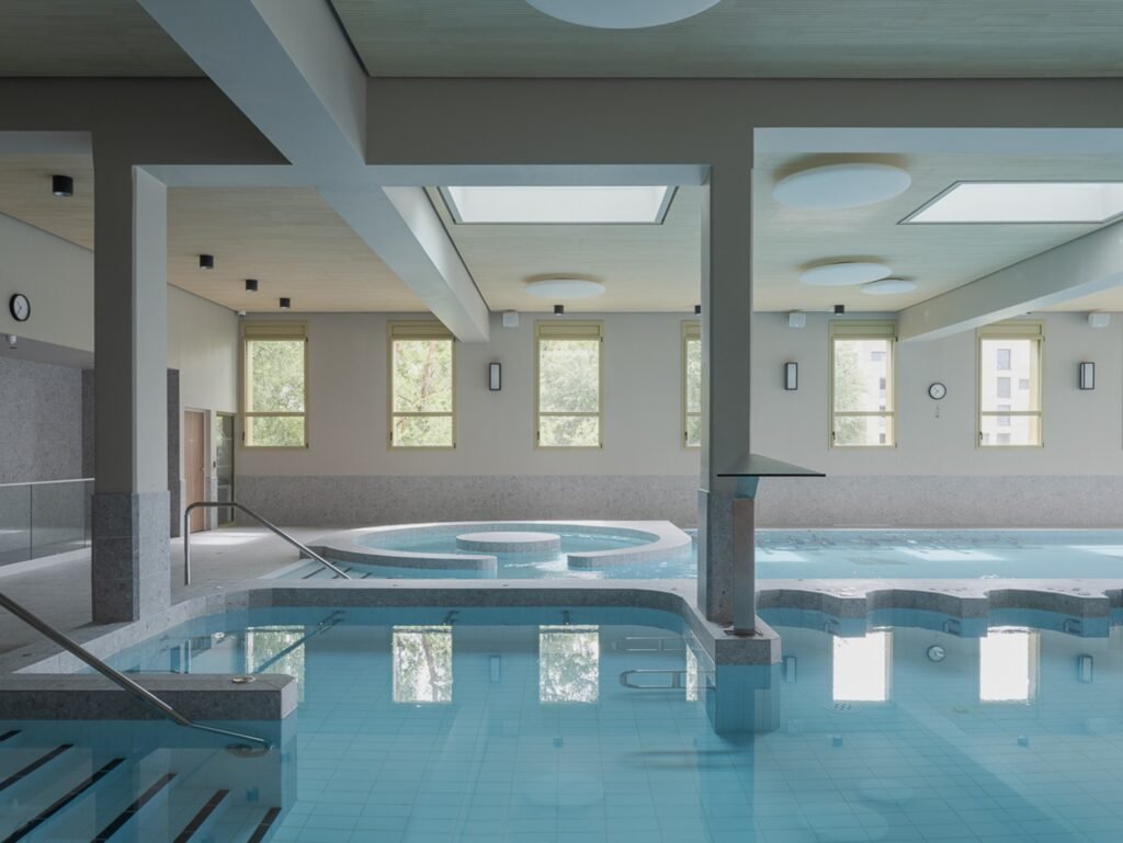 Hydrotherapy pool interior at Donnan Health Center with skylights and structural columns.