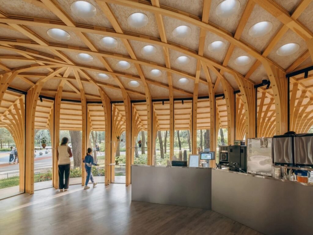 Interior view of the florist and coffee counter under a vaulted timber ceiling featuring circular skylights.