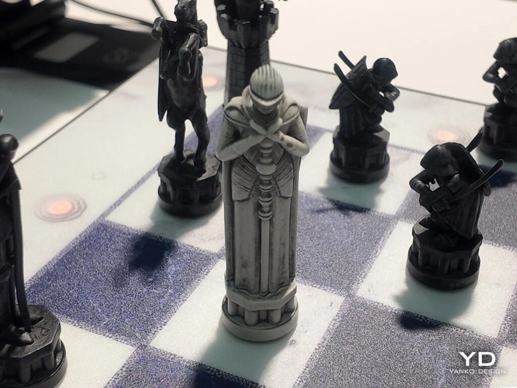 Front view of a carved king piece in armored attire standing centrally on a marble chess square.
