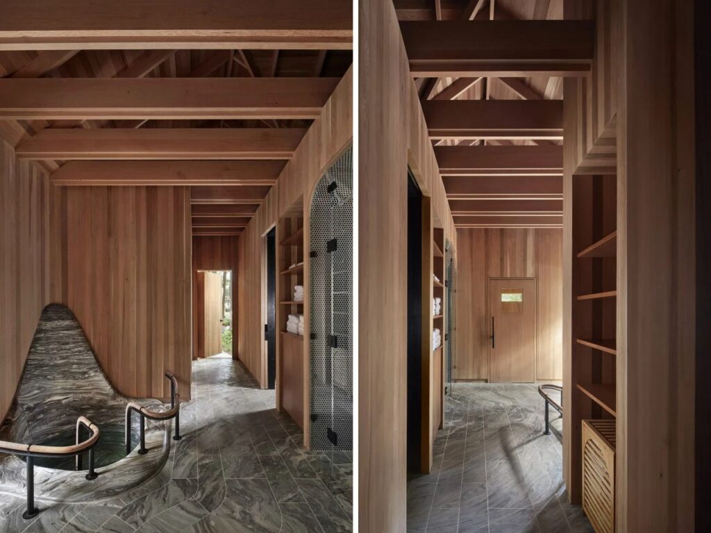 Internal hallway featuring dark granite plunge tub, timber ceiling beams, and stone flooring.