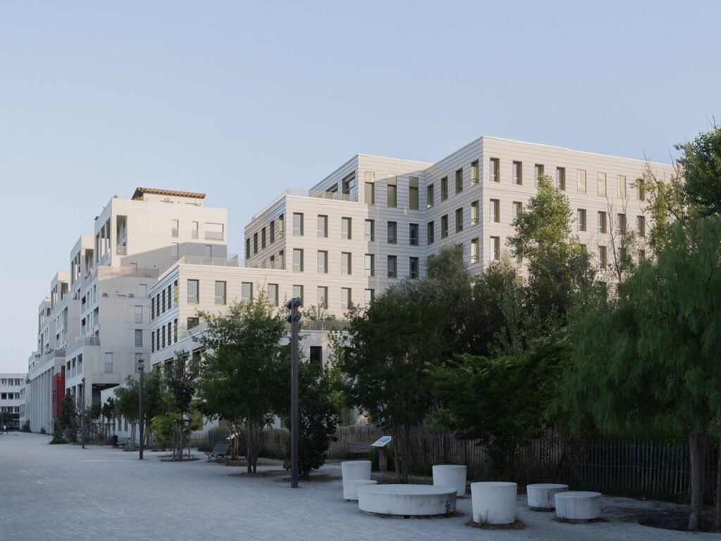 Donnan Health Center facade viewed across a tree-lined pedestrian promenade in Bordeaux.