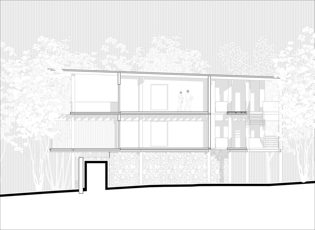 A detailed technical architectural cross-section drawing of a two-story building, showing interior rooms, furniture, a staircase, the pitched roof structure, and the relationship between the built structure and the sloped, rocky terrain, with tree outlines.