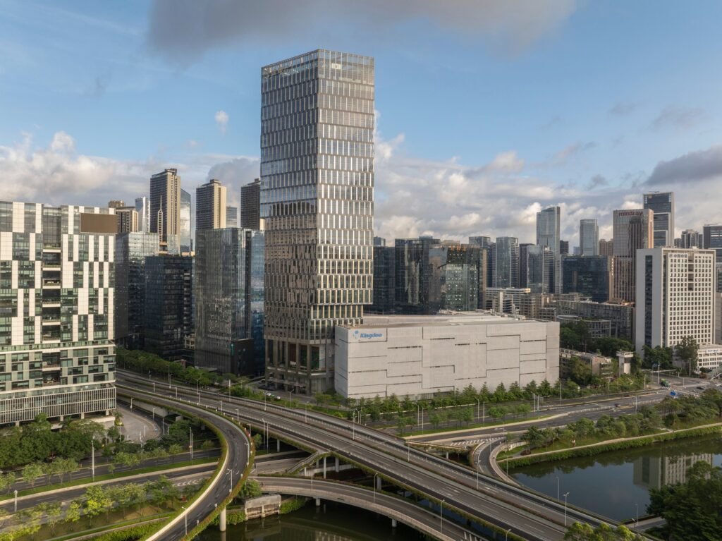 High aerial view of Kingdee HQ Tower integrated into the complex urban infrastructure and highway interchange.