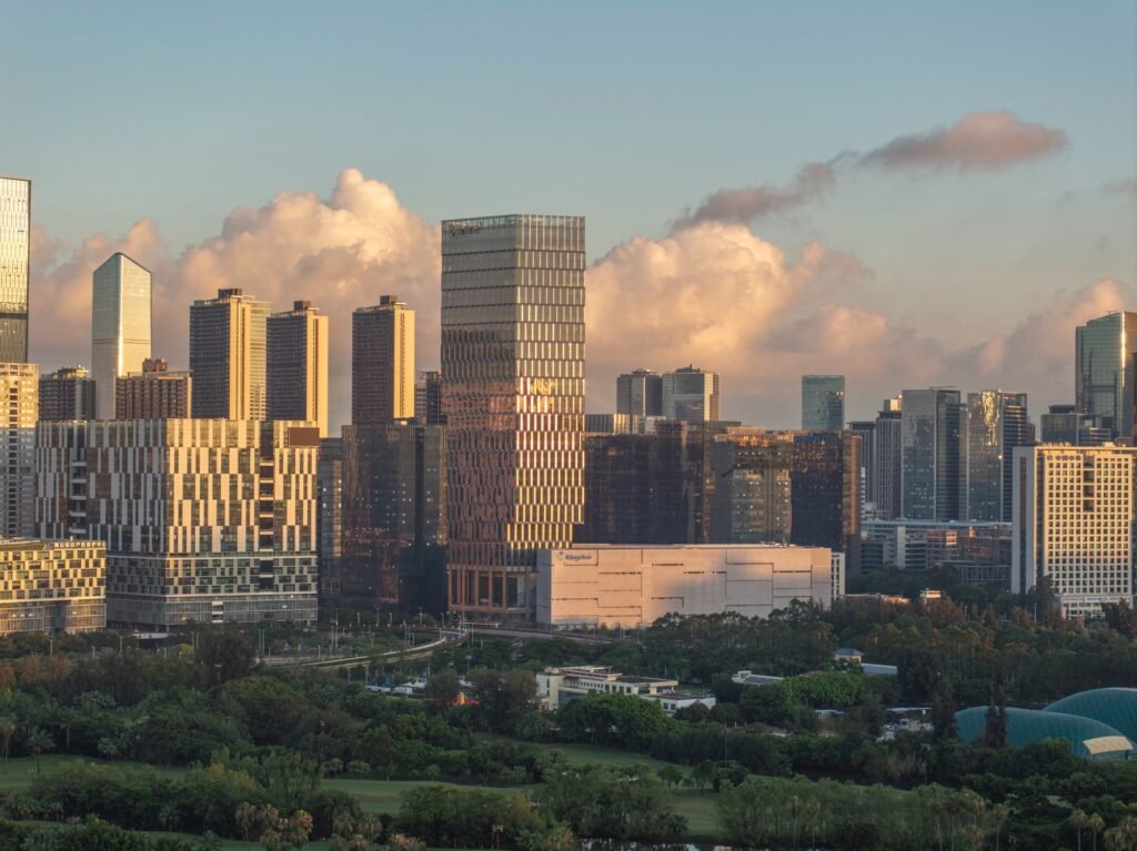 Distant skyline shot of Kingdee HQ Tower in Nanshan district lit by warm sunlight.