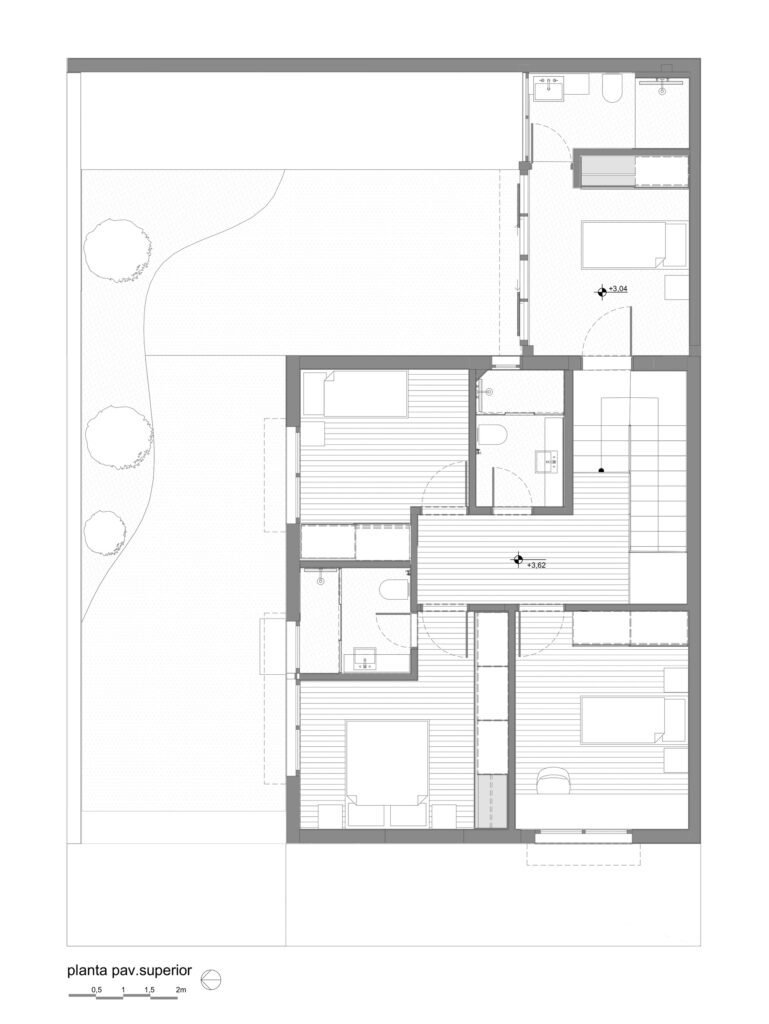 Architectural upper floor layout plan showing private bedrooms, bathrooms, and central circulation corridor around the staircase.
