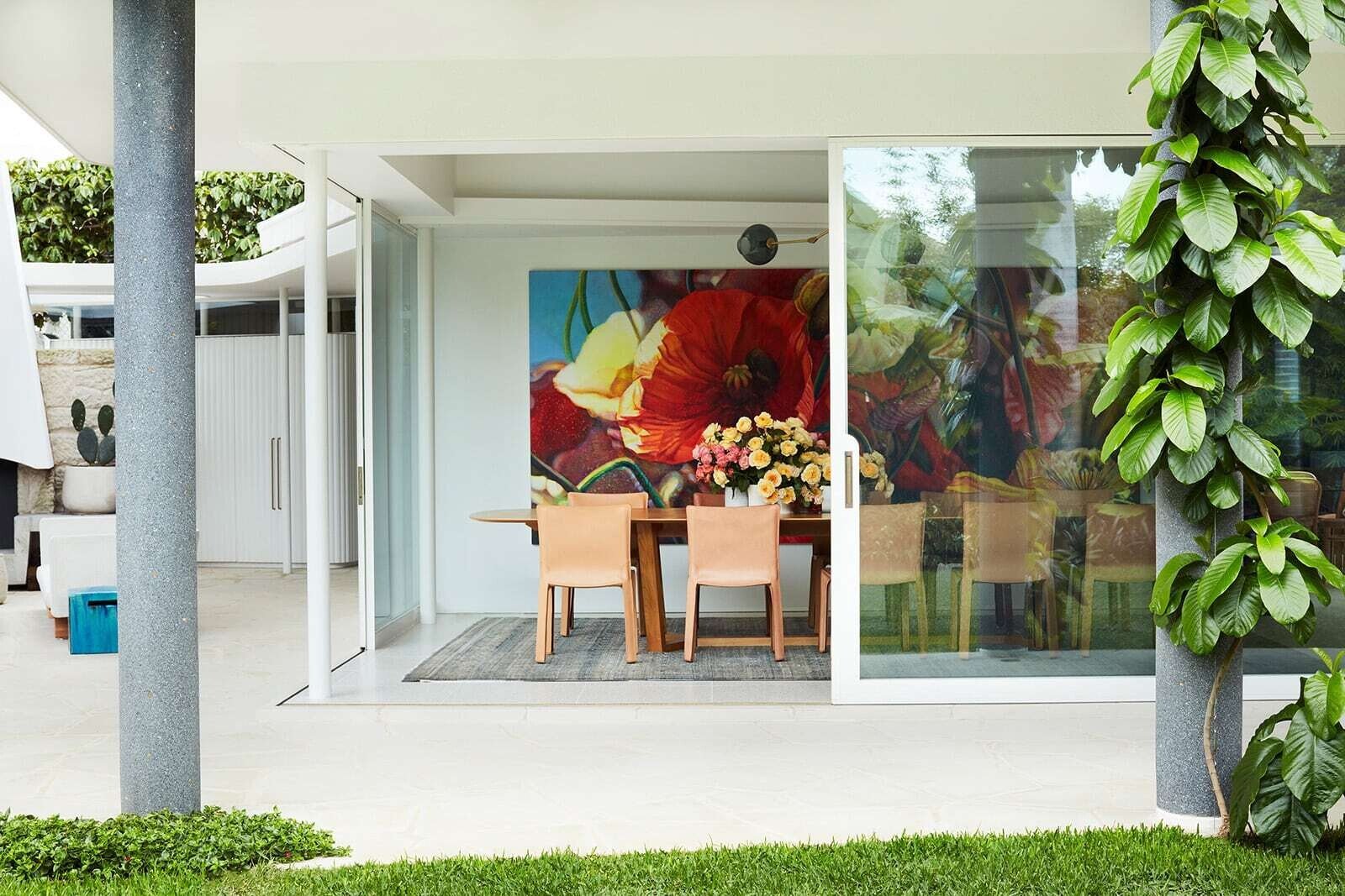 Outdoor lounge with fireplace beside the house