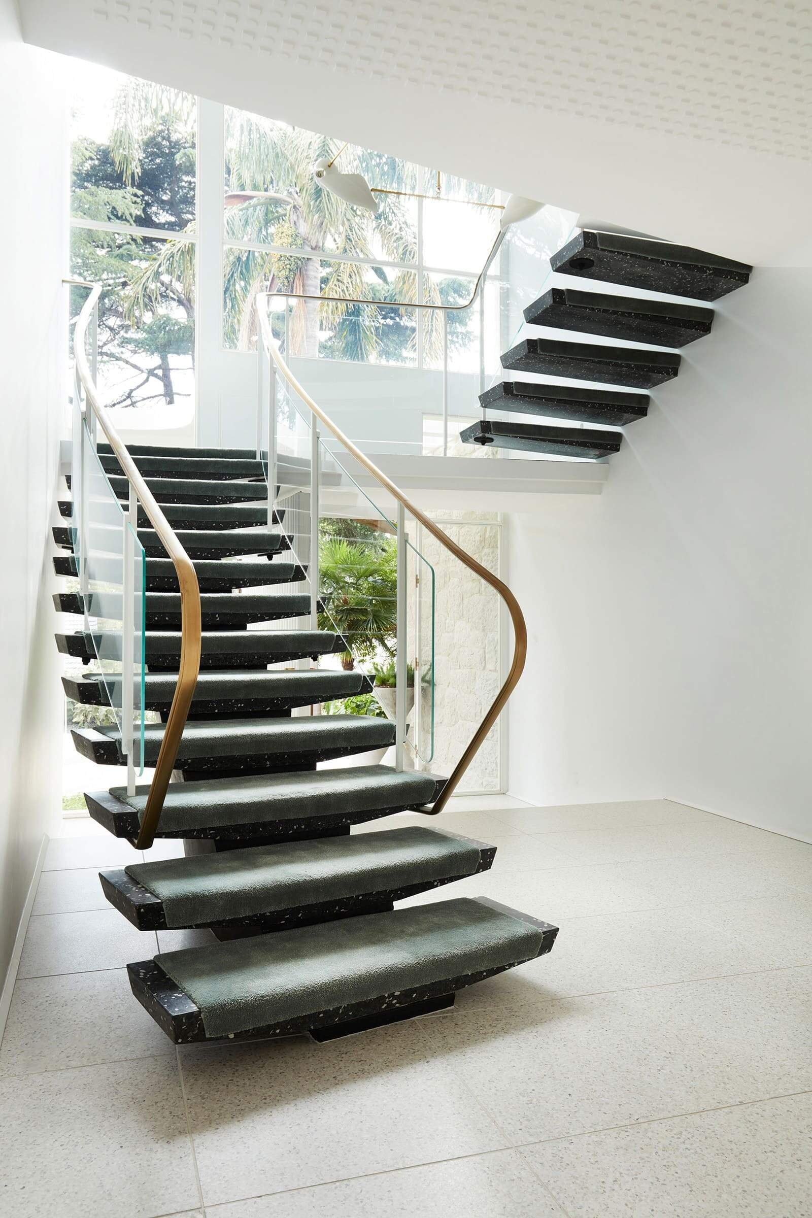 Restored switchback stair with brass handrail