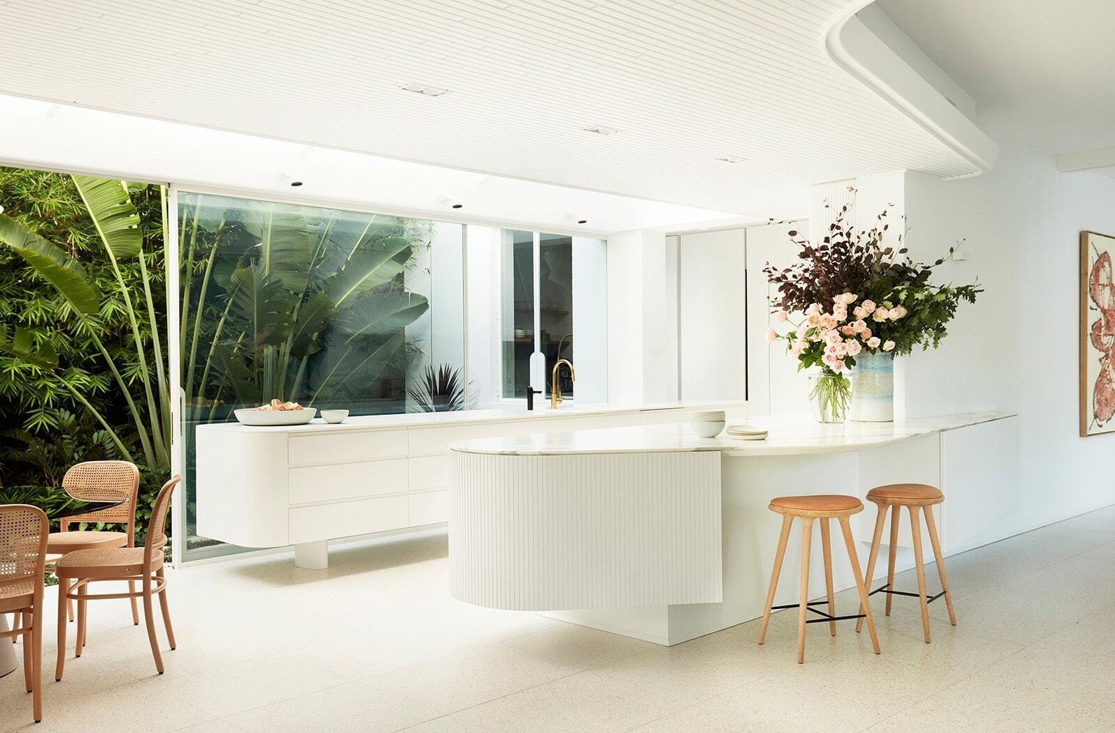 White kitchen and dining room facing the garden