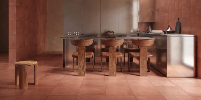 Terracotta-toned ceramic surfaces and furniture-scale tile applications presented around Cersaie 2026