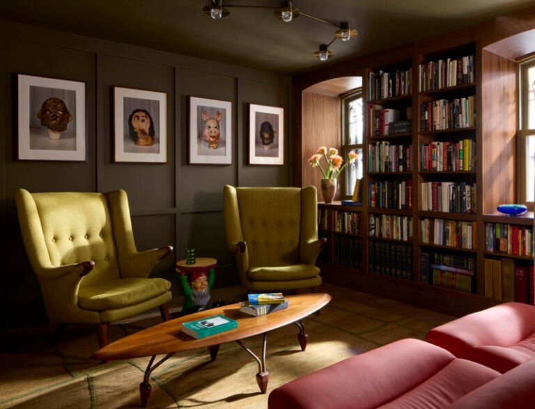 Walnut bookshelves and green Papa Bear chairs in the Clinton Hill brownstone library