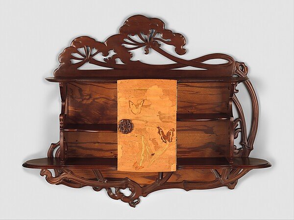 &Eacute;mile Gall&eacute;'s wooden cabinet with branching supports, open shelves and plant marquetry across its central veneered door.